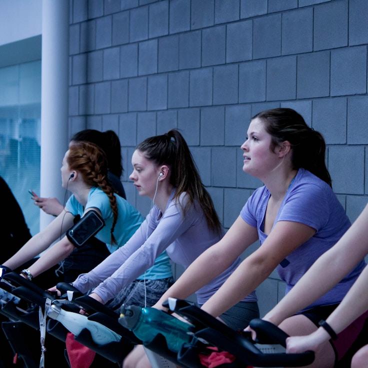 Women in a fitness class doing stretching and mobility exercises